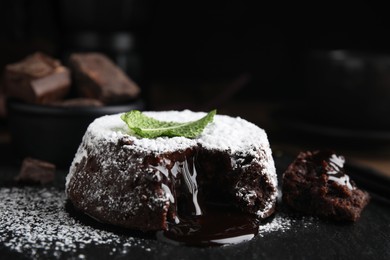 Delicious fresh fondant with hot chocolate and mint on slate plate, closeup
