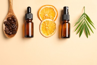 Photo of Bottles of organic cosmetic products, coffee beans, dried orange slices and green leaf on beige background, flat lay. Space for text