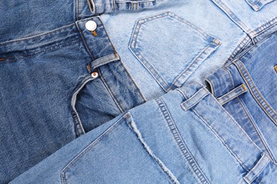 Photo of Variety of jeans with different pockets as background, closeup
