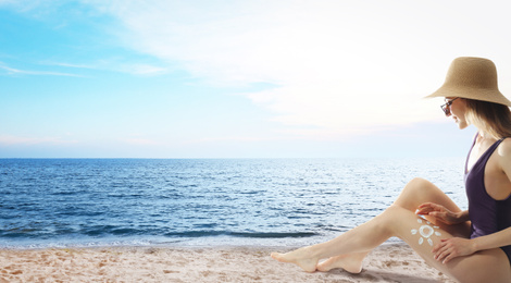 Young woman applying sun protection cream on leg near sea, space for text. Banner design