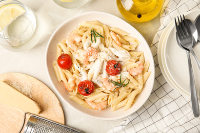Delicious pasta with shrimps on marble table, flat lay