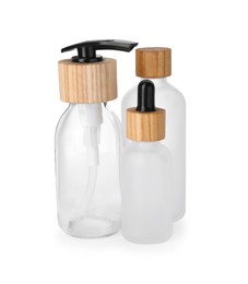 Different glass bottles with dropper and dispenser cap isolated on white