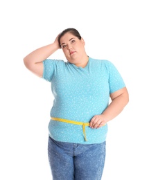 Photo of Overweight woman measuring waist before weight loss on white background