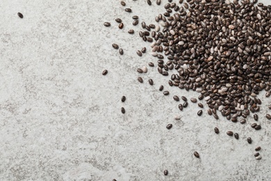 Photo of Pile of chia seeds on light grey table, flat lay. Space for text