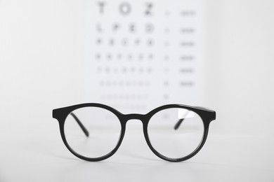 Glasses on light background, closeup. Ophthalmologist prescription