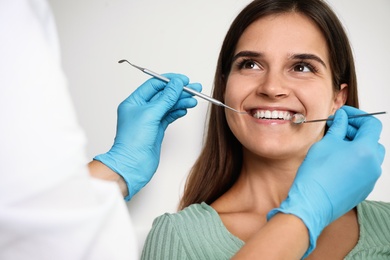 Dentist examining patient's teeth in modern clinic. Cosmetic dentistry