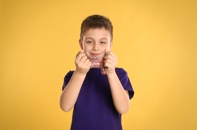 Photo of Little boy with slime on yellow background
