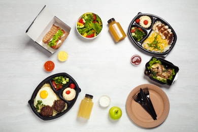 Frame made of lunchboxes on white table, top view with space for text. Healthy food delivery