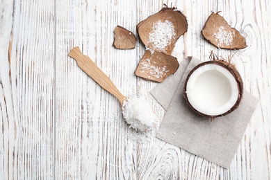 Composition with fresh coconut flakes on wooden background, top view