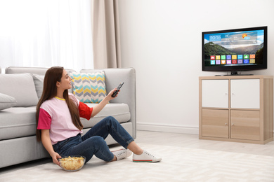 Woman watching smart TV in living room