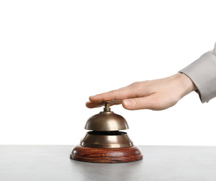 Woman ringing hotel service bell at grey stone table