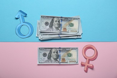 Photo of Gender pay gap. Male and female symbols with dollar banknotes on color background, flat lay