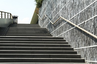 Photo of Stairs with metal handrailing outdoors on sunny day