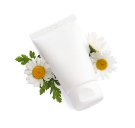 Tubes of hand cream and chamomiles on white background, top view
