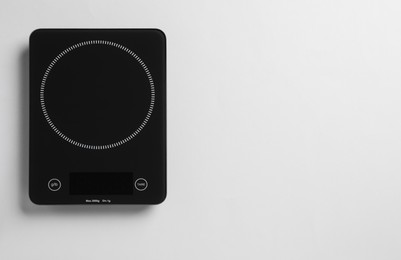 Modern digital kitchen scale on white background, top view. Space for text