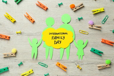 Happy Family Day. Flat lay composition with paper figures of parents and their children on wooden background