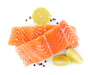 Fresh raw salmon with pepper, lime and lemon on white background, top view. Fish delicacy