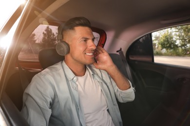 Man listening to music in modern taxi