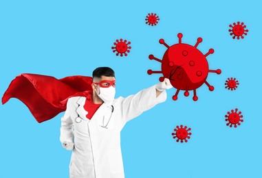 Doctor wearing face mask and superhero costume fighting against viruses on light blue background