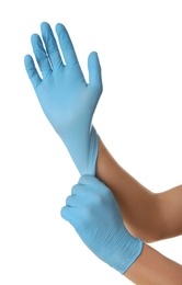 Person putting on blue latex gloves against white background, closeup