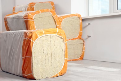 Packages of thermal insulation material in room. Space for text