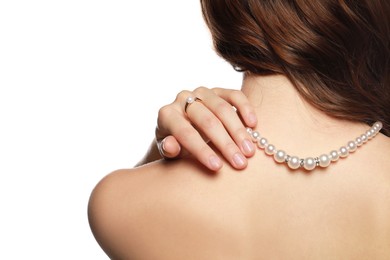 Young woman wearing elegant pearl jewelry on white background, back view