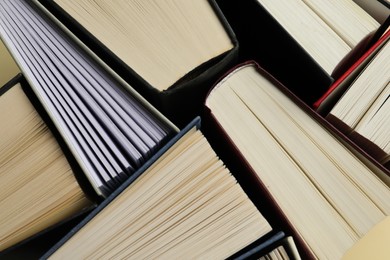 Photo of Many hardcover books as background, closeup view