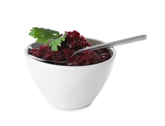 Photo of Delicious beetroot puree with parsley and spoon in bowl isolated on white. Healthy food