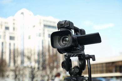 Professional digital video camera on city street
