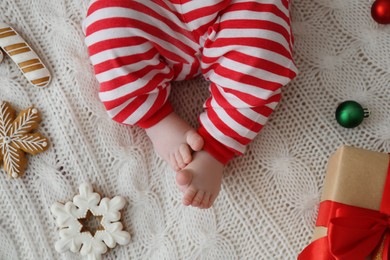 Cute little baby and Christmas decorations on blanket, top view