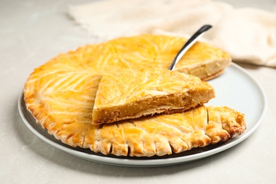 Traditional galette des rois on light grey marble table, closeup