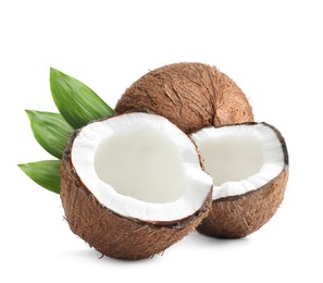 Tasty ripe coconuts and green leaves on white background