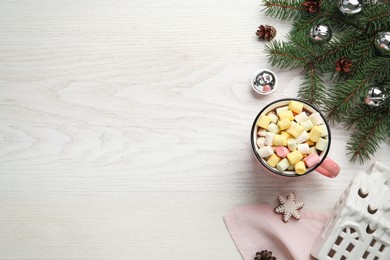 Delicious hot chocolate with marshmallows and Christmas decor on white wooden table, flat lay. Space for text