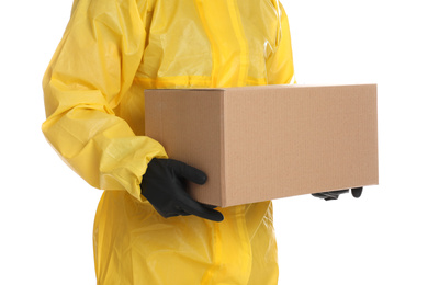 Man wearing chemical protective suit with cardboard box on white background, closeup. Prevention of virus spread