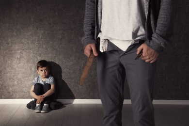 Man with unzipped pants and scared little boy indoors. Child in danger