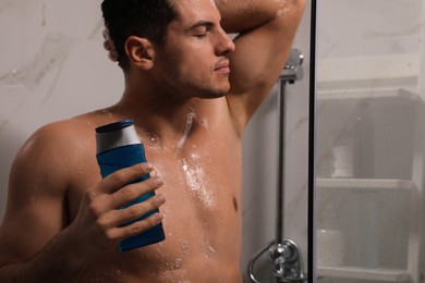 Man using gel in shower at home