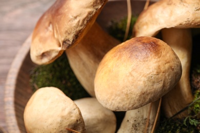 Fresh wild porcini mushrooms in wooden bowl, closeup