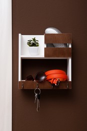 Stylish hanger for keys on brown wall in hallway