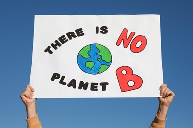 Man with poster protesting against climate change outdoors, closeup