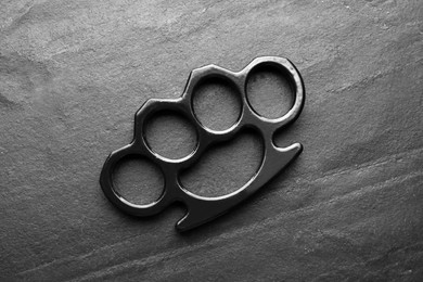 Brass knuckles on black background, top view