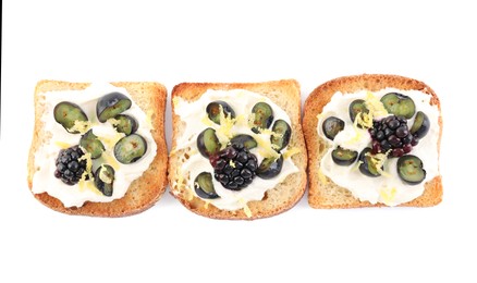 Tasty sandwiches with cream cheese, blueberries, blackberries and lemon zest on white background, top view