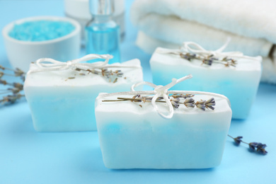 Natural handmade soap bars on light blue background, closeup