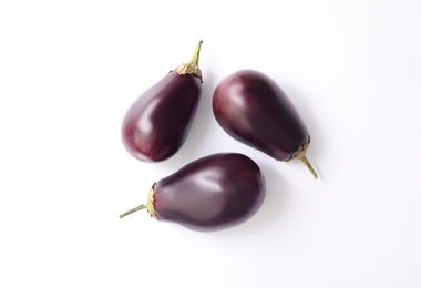 Raw ripe eggplants on white background, flat lay