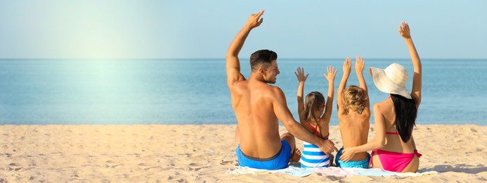 Happy family on sandy beach near sea, space for text. Banner design