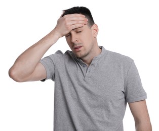 Young man suffering from headache on white background. Cold symptoms
