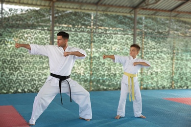Boy and coach practicing karate at outdoor gym
