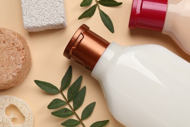 Flat lay composition with solid shampoo bar and bottles of cosmetic product on beige background