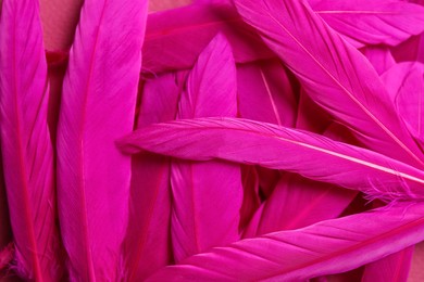 Many beautiful fluffy magenta feathers as background, top view