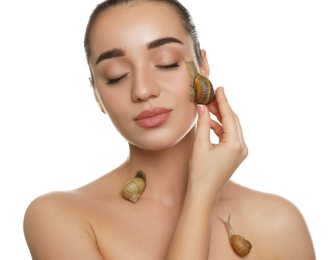 Photo of Beautiful young woman with snails on her body against white background