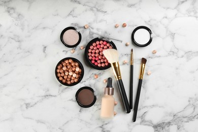 Flat lay composition with makeup brushes on white marble table